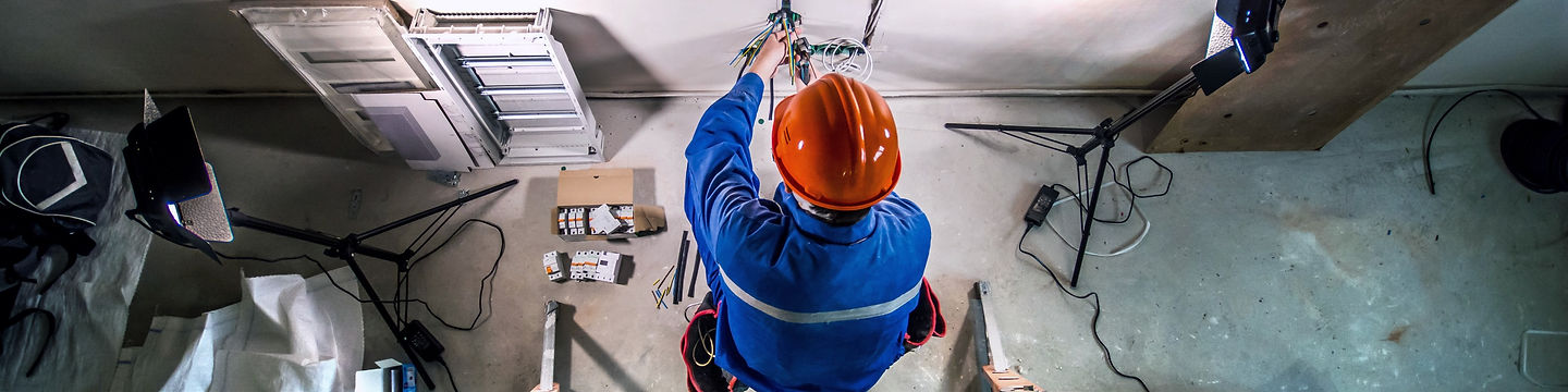 Professional Cairns electrician working on a switchboard
